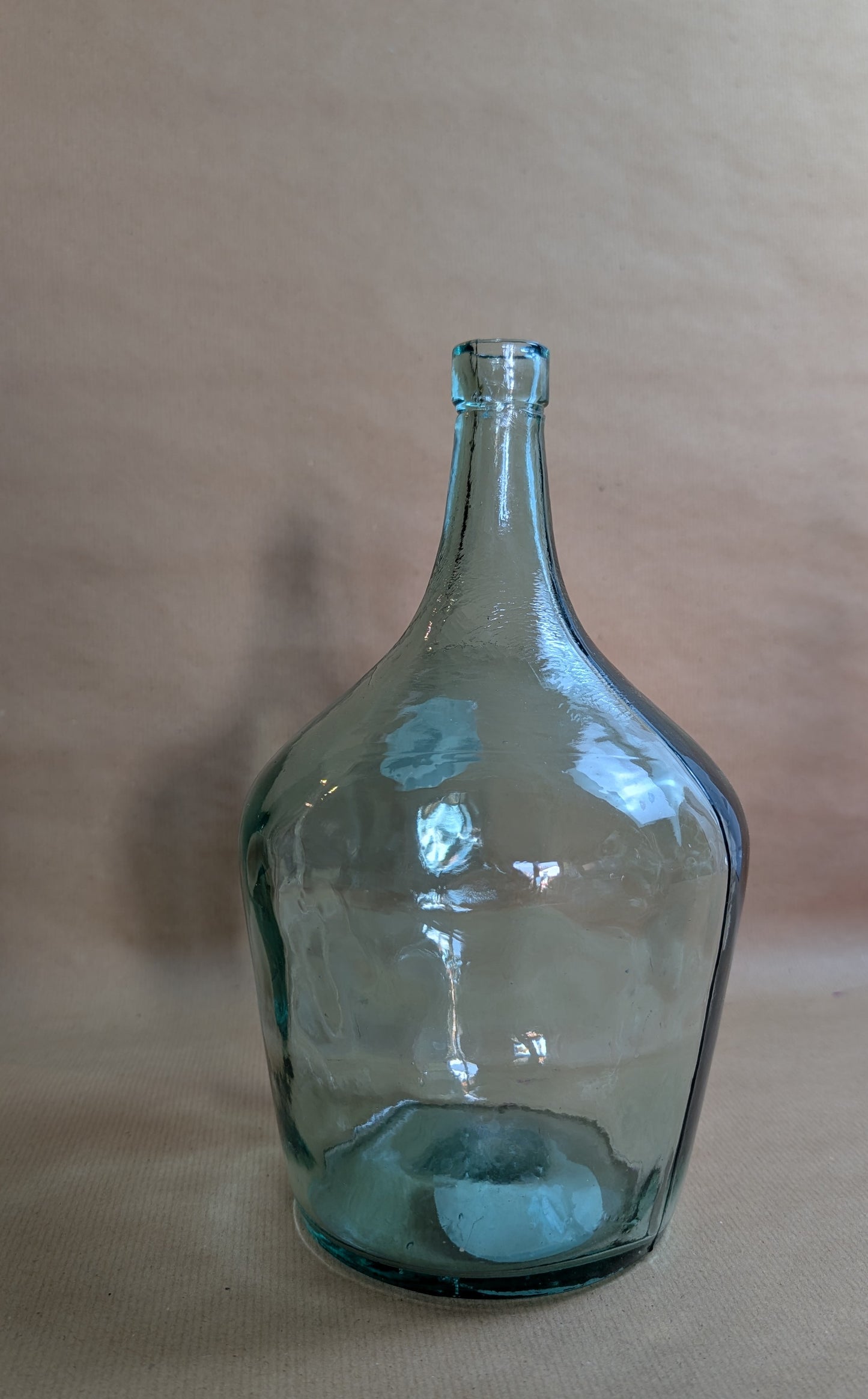 Clear glass bottle on a beige background