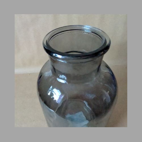 Clear glass bottle on a beige background
