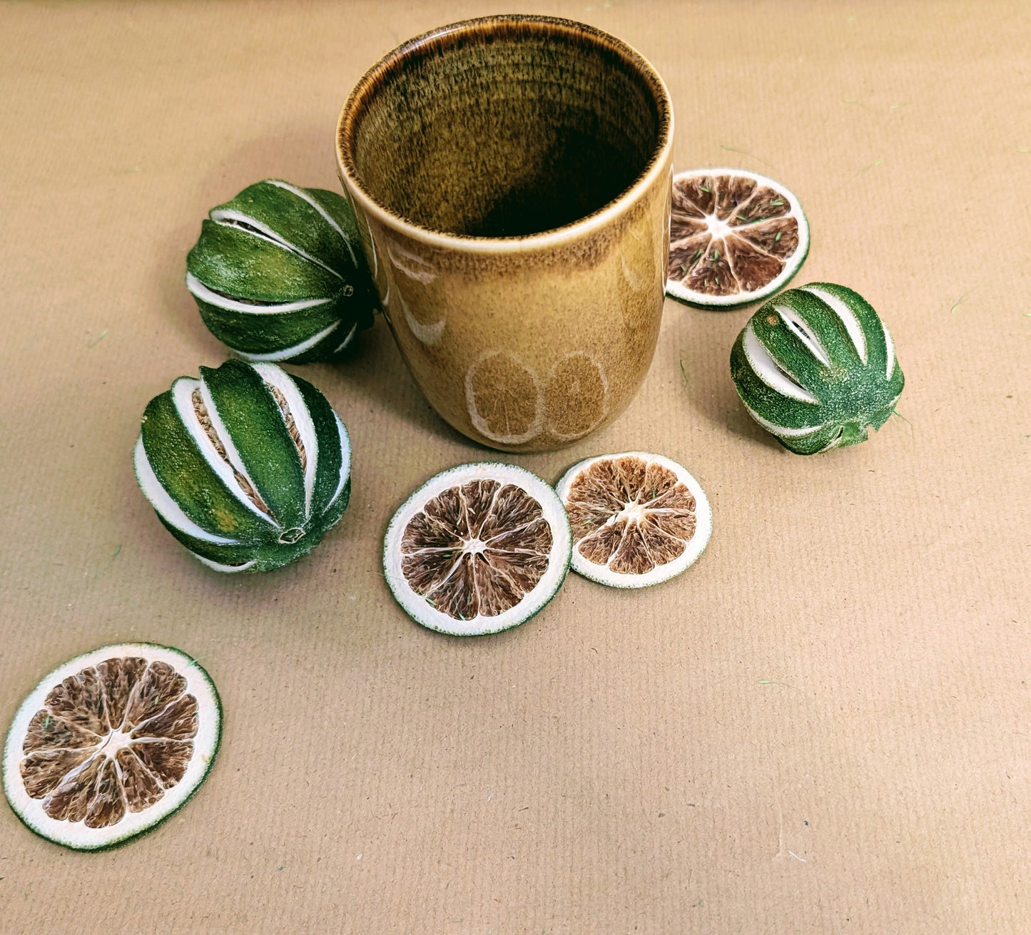 Ceramic cup with decorative items on a beige surface