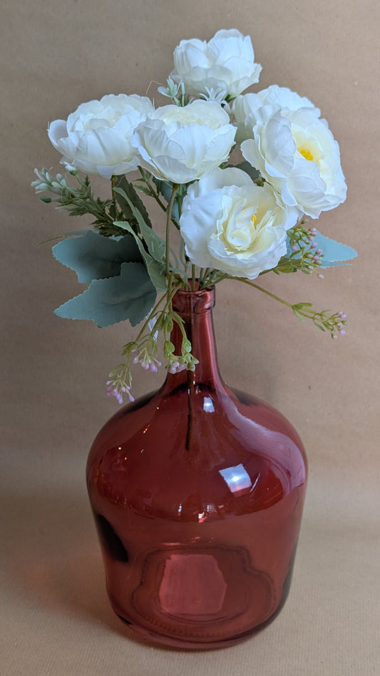 Red glass flower holder with white flower bouquet