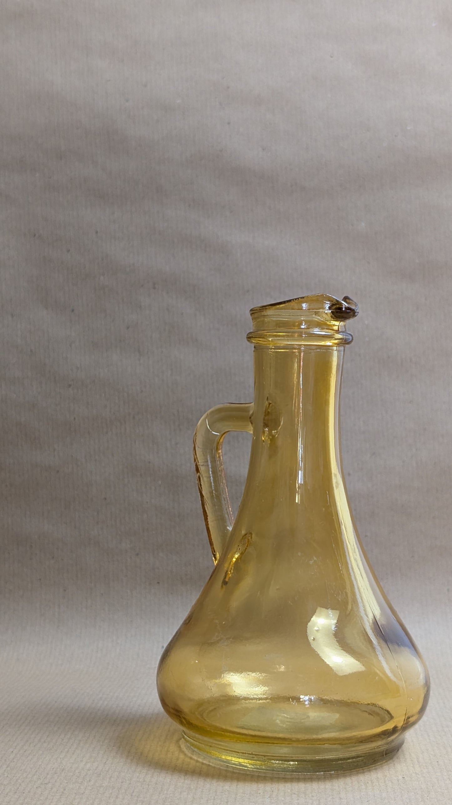 Clear glass carafe on a gray background