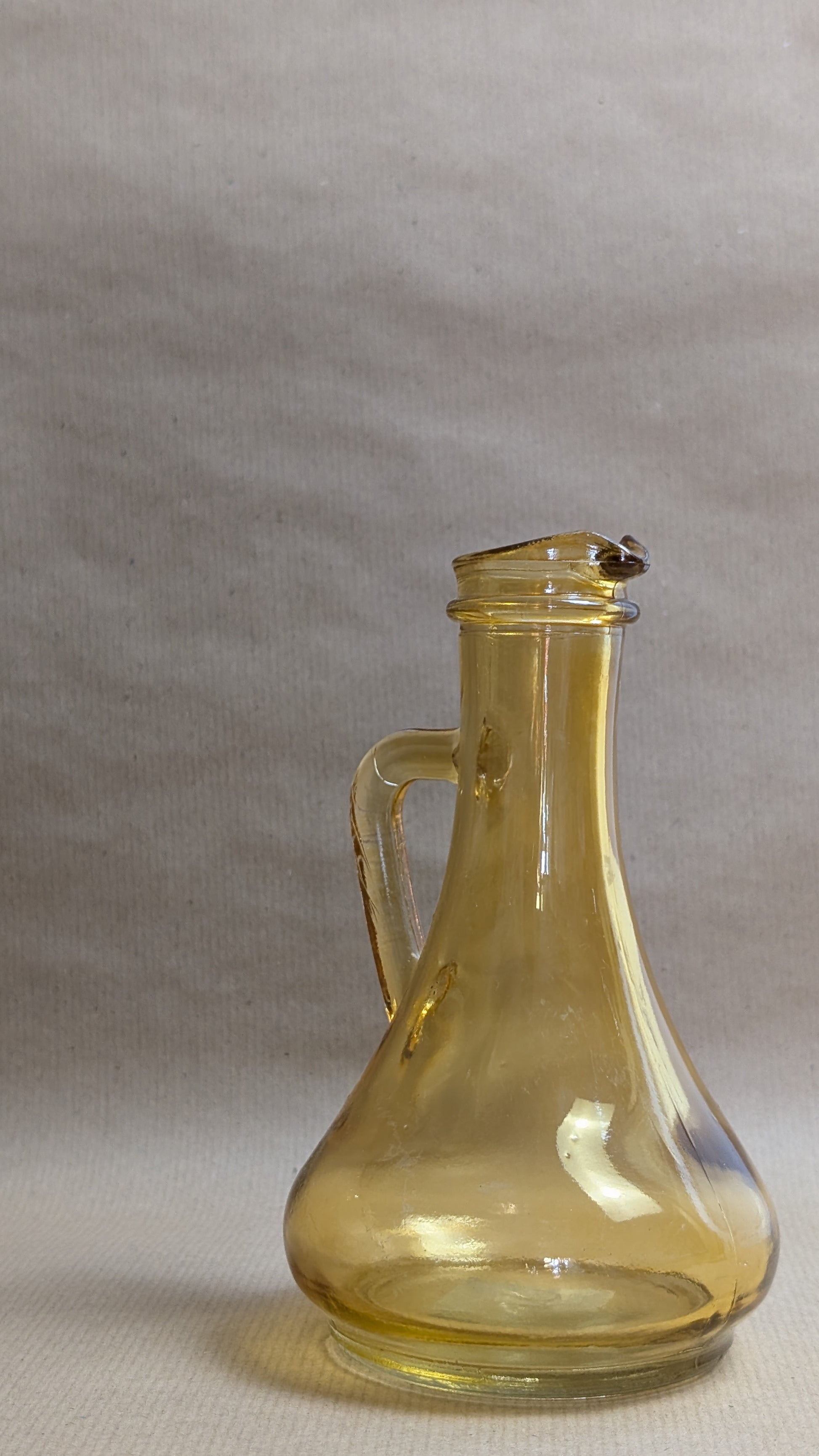 Clear glass carafe on a gray background